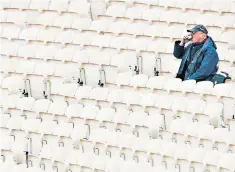  ??  ?? Lonely view: a spectator at a poorly attended game at Old Trafford several years ago