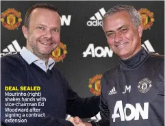  ??  ?? DEAL SEALED Mourinho (right) shakes hands with vice-chairman Ed Woodward after signing a contract extension