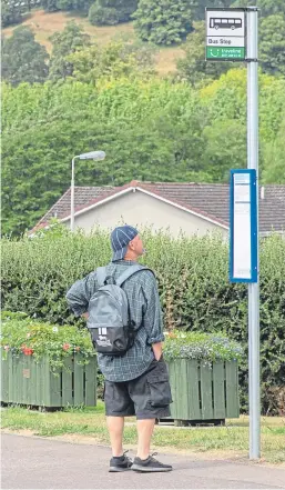  ?? Picture: Steven Brown. ?? A member of the public waiting for a bus in St Madoes.