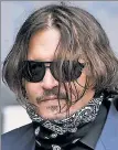 ??  ?? TROUBLE DIGITS: Johnny Depp (above Thursday) testified that, amid a three-day battle with then-wife Amber Heard (below Thursday), she severed his finger with a bottle of vodka, so he wrote, “I love you,” on a mirror in his blood.