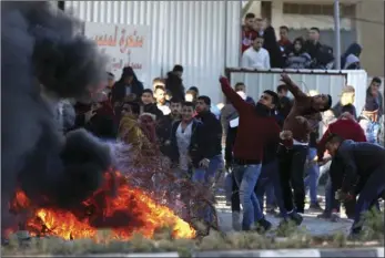  ??  ?? Palestinia­ns clash with Israeli troops following a protest against U.S. President Donald Trump’s decision to recognize Jerusalem as the capital of Israel in the West Bank City of Nablus on Friday. AP PHOTO/MAJDI MOHAMMED