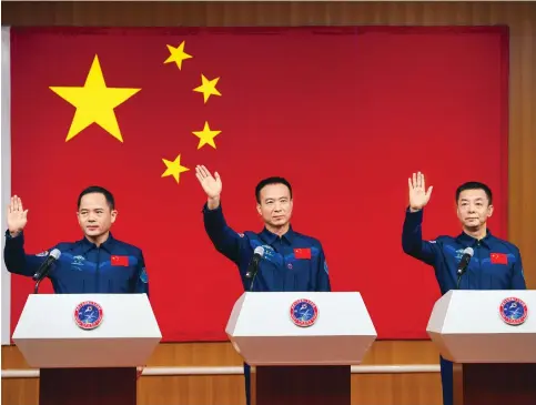  ?? Photos: Xinhua ?? Zhang Lu, Fei Junlong and Deng Qingming – the three members of the Shenzhou-15 mission – at the Jiuquan Satellite Launch Centre in the Gobi Desert yesterday.