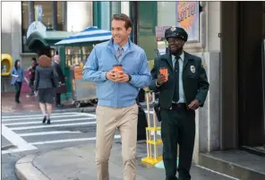  ?? The Associated Press ?? This image released by 20th Century Studios shows Ryan Reynolds, left, and Lil Rel Howery in a scene from Free Guy.