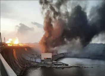  ?? Telegram Channel of Ukraine's Prime Minister Denys Shmyhal via AP in ?? Smoke and fire rise over the Dnipro hydroelect­ric power plant Friday after Russian attacks Dnipro, Ukraine.