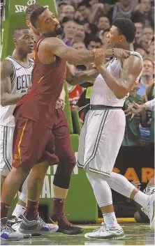  ?? STAFF PHOTO BY CHRISTOPHE­R EVANS ?? STRONG DEFENSE: Marcus Smart gets in a tussle with the Cavaliers’ J.R. Smith, whose push of Al Horford drew a Flagrant 1 foul in the fourth quarter of the Celtics’ Game 2 victory Tuesday night at the Garden.