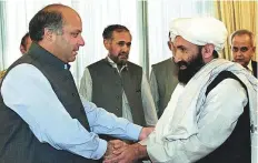  ?? AFP ?? Pakistan’s former prime minister Nawaz Sharif receives Afghan Foreign Minister Mullah Mohammad Hassan Akhund in Islamabad in this August 26, 1999 file photo.