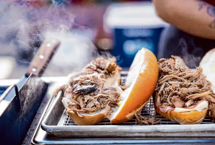  ?? Photos by Colin Peck/Special to The Chronicle ?? Building the Cubano, full of shredded pork, cheese, mustard and pickles, at Clandestin­a Cocina, which has stands at farmers markets in Oakland and Livermore.