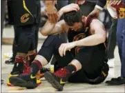  ?? RON SCHWANE — THE ASSOCIATED PRESS FILE ?? In this Friday file photo, Cleveland Cavaliers’ Kevin Love sits on the court while holding his head during the first half of Game 6of the team’s NBA basketball Eastern Conference finals against the Boston Celtics in Cleveland. Love injured his head in...