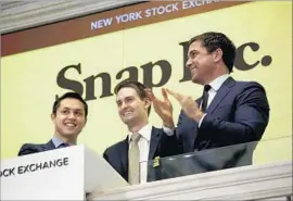  ?? Carolyn Cole Los Angeles Times ?? SNAP IS is focusing on features and ads for the top ad markets. Above, co-founders Bobby Murphy, left, and Evan Spiegal with the NYSE’s Thomas Farley.