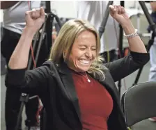  ?? ROB SCHUMACHER/THE REPUBLIC ?? Kristen Lovullo, wife of Arizona Diamondbac­ks manager Torey Lovullo, reacts during a news conference after he was named National League Manager of the Year on Tuesday.