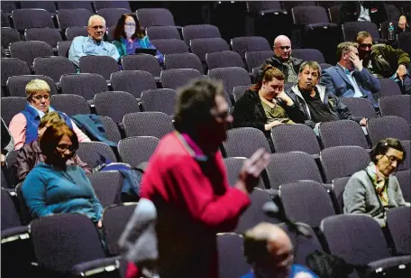  ?? SARAH GORDON/THE DAY ?? Audience members listen as Tom McCormick, with the Citizen Awareness Network, speaks during a hearing about Millstone on Tuesday at Waterford High School. State regulators evaluating Millstone’s financial status listened to public comments during the...