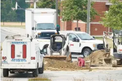  ?? ALEX SLITZ/THE CHARLOTTE OBSERVER ?? Work continues Friday in the parking lot after reports of a water line break at Whitewater Academy in Charlotte, N.C.