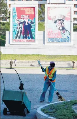 ?? Photog r aphs by Julie Makinen Los Angeles Times ?? ACROSS PYONGYANG, North Korean workers have been spiff ing up their city. New propaganda banners have sprung up across the spartan metropolis.