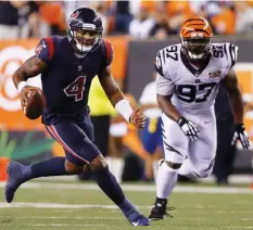  ?? (Reuters) ?? IN HIS first NFL start, Houston Texans rookie quarterbac­k Deshaun Watson (left) ran 49 yards for a second-quarter touchdown and led the Texans’ depleted offense to a late clinching field goal in a 13-9 road victory over the Cincinnati Bengals on...