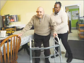  ?? Erik Trautmann / Hearst Connecticu­t Media ?? STAR resident Jimmy Natale gets help from his aid Inez Brown on Friday at his group home in Norwalk.