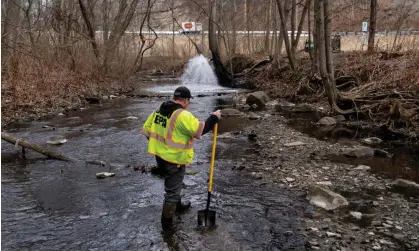  ?? Photograph: Michael Swensen/Getty Images ?? Ron Fodo, from Ohio EPA Emergency Response, inspects a creek on 20 February 2023 in East Palestine, Ohio.