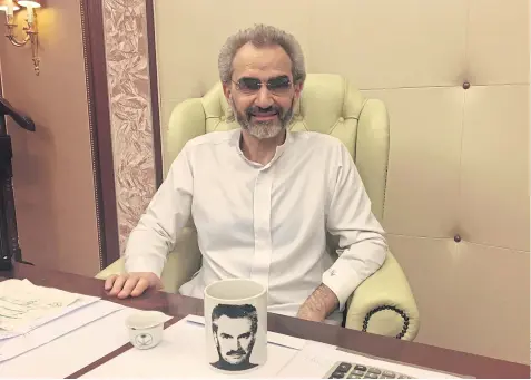  ??  ?? BEARING UP: Saudi Arabian billionair­e Prince Alwaleed bin Talal sits for an interview in his suite at the Ritz-Carlton.