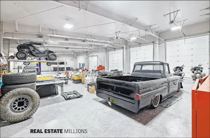  ?? Napoli Group ?? REAL ESTATE MILLIONS
On one side of the reimagined property is a 5,000-square-foot four-bay garage and workshop that holds up to 22 cars and also serves as an air-conditione­d man cave with a bar.