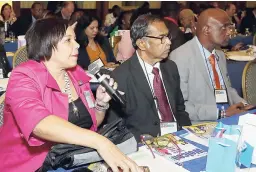  ??  ?? Corah Ann Robertson-Sylvester (with mike) reponds to the panel at the Caribbean Shipping Associatio­n’s 47th Annual General Meeting Conference and Exhibition, held in Barbados from October 9-11. To her left are Harriat Maragh, group chairman of Lannaman...