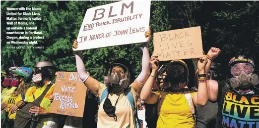  ?? ALISHA JUCEVIC/GETTY IMAGES ?? Women with the Moms United for Black Lives Matter, formerly called Wall of Moms, line up outside a federal courthouse in Portland, Oregon, during a protest on Wednesday night.