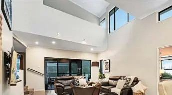  ?? Photos: SHANE ROBSON ?? HIGH EXPECTATIO­NS: You’ll be impressed by the huge living and dining room with soaring high ceilings and plenty of natural light.