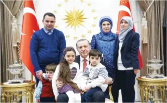  ??  ?? Turkey’s President Recep Tayyip Erdogan (center) and his wife Emine (second right) pose with seven-year-old Bana Al-Abed (third left), who tweeted from Aleppo, and her family at the Presidenti­al Complex.