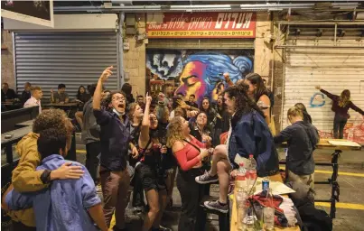  ?? (Olivier Fitoussi/Flash90) ?? JOYOUS, LARGELY maskless patrons dance at a bar in Jerusalem’s shuk, as eateries and nightlife spots reopened on May 27.