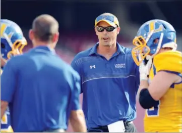  ??  ?? Hot Springs Lakeside coach Jared McBride, second from right, talks to players and assistant coaches during a game in 2014.