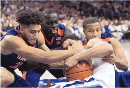  ?? CHRIS SZAGOLA/ASSOCIATED PRESS ?? Villanova’s Josh Hart, center right, battles for the ball with Virginia’s Isaiah Wilkins, left, Marial Shayok, center left, and Devon Hall, right, during Sunday’s game.