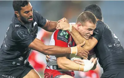  ?? Photograph: Getty ?? Euan Aitken of the Dragons is tackled in a game against South Sydney Rabbitohs