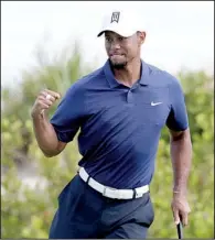  ?? AP/LYNNE SLADKY ?? Tiger Woods reacts after making a par-saving putt on the 16th hole at the Hero World Challenge on Friday. Woods shot a bogey-free, 7-under-par 65 on Friday.