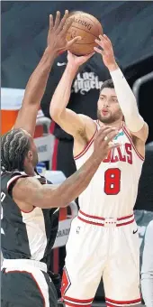  ?? MARCIO JOSE SANCHEZ/AP ?? Zach LaVine shoots over Los Angeles Clippers forward Kawhi Leonard on Sunday. LaVine hit 10 three-pointers, a career best.