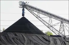  ?? NATI HARNIK / AP 2014 ?? A hill of coal awaits burning at the North Omaha power station in Omaha, Neb. At the Trump administra­tion’s request, a federal appeals court agreed Friday to postpone a ruling on lawsuits challengin­g restrictio­ns on carbon emissions.