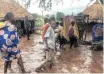  ??  ?? RESIDENTS of Chiluvi, Mozambique, walk along a flooded street after cyclone Idai hit the region last week. | EPA-EFE African News Agency (ANA)