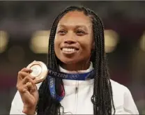  ?? Associated Press ?? Sprinter Allyson Felix displays the gold medal Saturday that made her the most decorated Olympic track athlete in American history. A win in the women’s 4x400 relay gave her an 11th career medal, breaking a tie with Carl Lewis