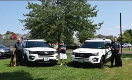  ?? PHOTOS BY MARIAN DENNIS — DIGITAL FIRST MEDIA ?? Officer Chris Wienczek with K-9 partner “Rambo” (left), Speck Landis (center) and Officer Kevin McGuigan with K-9 partner “Flynn” stand together outside the Limerick Township Police Department.