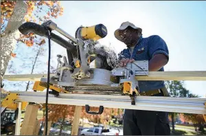  ?? (Arkansas Democrat-Gazette/Stephen Swofford) ?? Jesse Lawson works Tuesday on a treehouse being built along the Arkansas River in Riverfront Park in Little Rock.