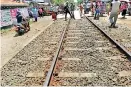  ??  ?? Family members and villagers block the Galle Road and main railway line (inset) and stage a protest against the alleged custodial killings. Pix by Gamini Mahadura and Sirangika Lokukarawi­ta