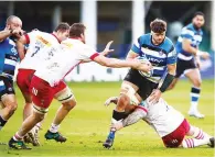  ??  ?? Mob handed: Bath’s Mike Williams is tackled by Stephan Lewies and Joe Marler, on ground