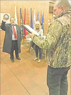  ?? Jeff Mill / Hearst Connecticu­t Media ?? Cromwell Fire District President LeRoy D. Brow, left, swears in new commission­er Charles Epstein following voting Monday, as Epstein’s wife, Diana, looks on.