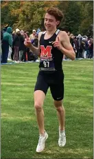  ?? BEN HERCIK — THE NEWS-HERALD ?? Mentor’s Billy Dennison celebrates as he crosses the line to win the Division I Madison District on Oct. 21.