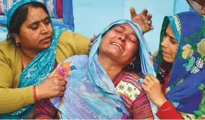  ?? PTI ?? Family members mourn the death of CRPF trooper Kaushal Kumar Rawat, at his home in Agra yesterday. Rawat was killed in the Pulwama attack.