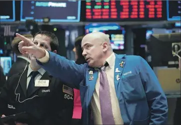  ?? Bryan R. Smith AFP/Getty Images ?? SOME TRADERS took the sharp sell-off as validation of an ongoing hunch that the stock market was overvalued, said René Nourse, a CNBC commentato­r: “When the coronaviru­s happened, it kicked the door down.”