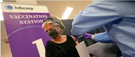  ?? MATT sTone / herAld sTAFF FIle ?? A SHOT AT MILLIONS: A woman gets her coronaviru­s vaccinatio­n in the former Sears in the Natick Mall. The state is paying a for-profit company hundreds of thousands of dollars a week for the site.