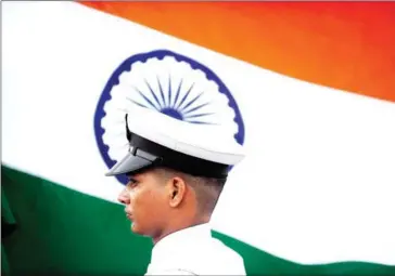  ?? INDRANIL MUKHERJEE/AFP ?? An Indian sailor holding the national flag participat­es in a rehearsal for a naval parade.