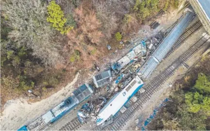  ?? Jeff Blake, The Associated Press ?? Wreckage rests on the tracks after a CSX freight train, left, and an Amtrak train collided early Sunday in Cayce, S.C.