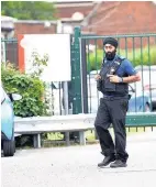  ??  ?? A Community Support Officer outside the school yesterday