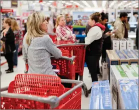  ?? AP Photo/John Minchillo ?? Black Friday: Shoppers wait in line for Apple iPhone purchases during a Black Friday sale at a Target store, Friday in Newport, Ky.