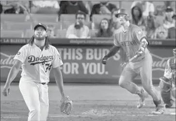  ?? Mark J. Terrill Associated Press ?? KENLEY JANSEN watches a game-tying, two-run home run by Arizona’s Carson Kelly in the ninth inning at Dodger Stadium. Kelly also homered off Julio Urias in the 11th to give the Diamondbac­ks the lead.