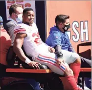  ?? Nam Y. Huh / Associated Press ?? Giants running back Saquon Barkley is carted to the locker room after being injured during the first half against the Bears in Chicago on Sunday.